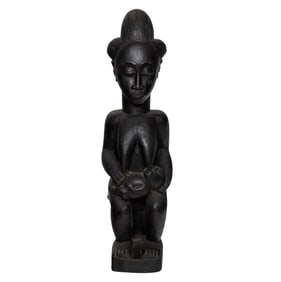 An African wood fertility figure with a baby