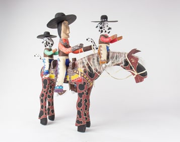 A Delbert Buck (Navajo) carved and painted wood whimsical group