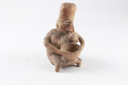 A Pre Columbian Nayarit style red clay seated fertility figure holding a bowl, 7"h