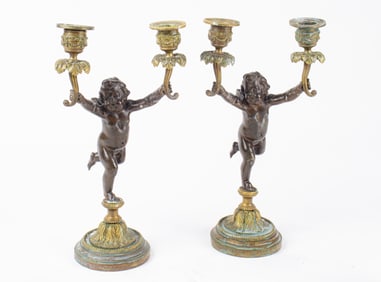 A pair of Louis XV style gilt and patinated bronze figural two-light candelabra