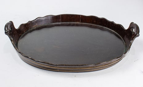 A Georgian style brass bound two-handled oval tray with serpentine rim