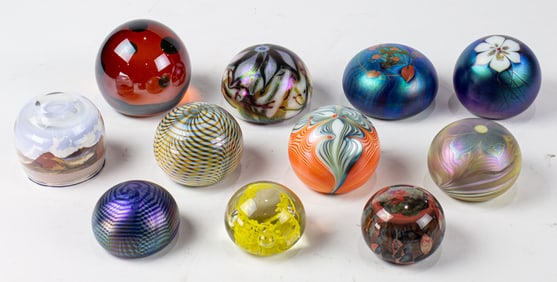 Eleven glass paperweights