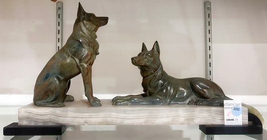An Art Deco patinated metal and onyx group of two dogs, after a model Louis-Albert Carvin