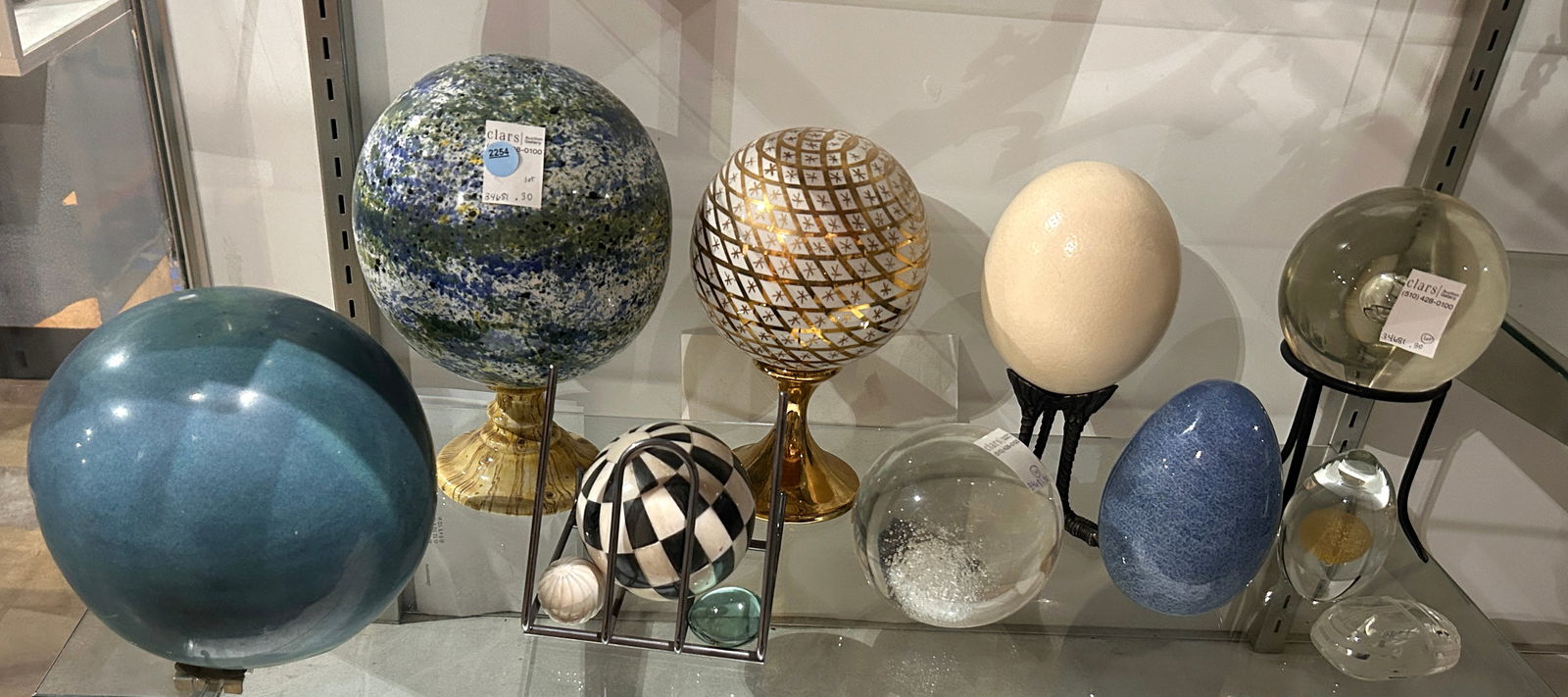 A collection of glass and other medium orbs and eggs: A collection of glass and other medium orbs and eggs, comprising (2) Barovier & Toso Murano glass egg paperweights, greatest 5.75"h; (3) ceramic orbs, greatest 10.5"h; (2) bone veneer orbs; (1) ostric