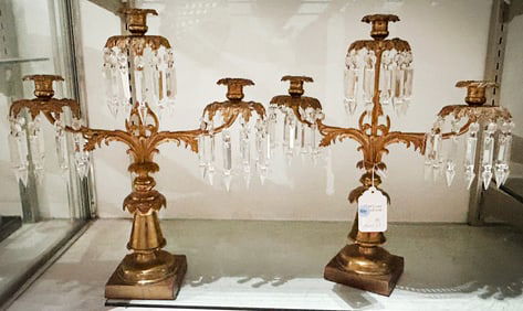 A pair of English brass three-light girandoles hung with cut glass prisms