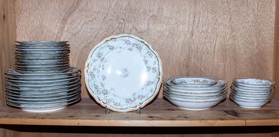A Haviland Limoges porcelain dinner service decorated with roses and gilt rims