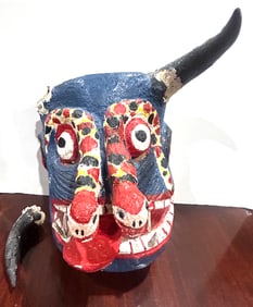 A Mexican Folk Art painted wood and horn mask of a devil