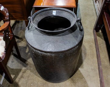 A large Indian hammered copper handled vessel
