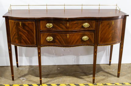 A Henkel Harris flame mahogany inlaid serpentine front sideboard