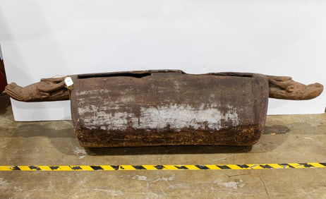 An antique Camaroon split carved wood drum with buffalo heads