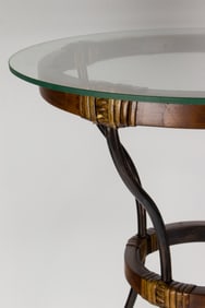 A contemporary glass top side table