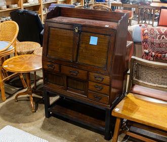 A Janese slant front desk on base, fitted with iron hardware