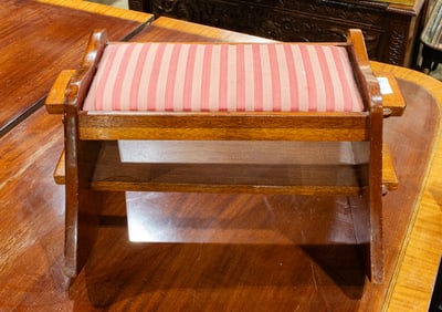 A mahogany rocking footstool with upholstered drop-in seat