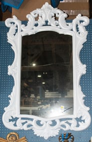 A large Louis XV style white framed mirror
