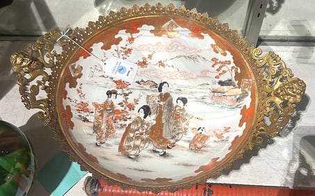 A Japanese Satsuma charger with gilt-metal mounts