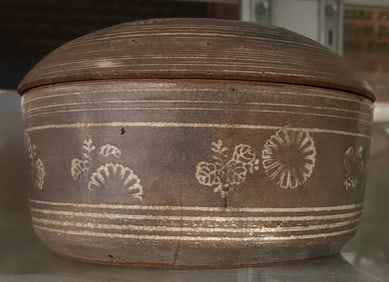 A Japanese inlaid-celadon stoneware circular box