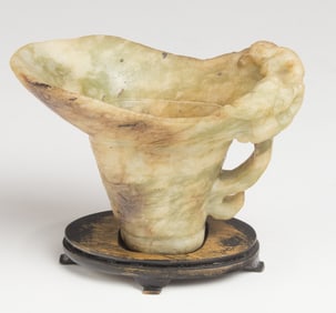 A Chinese jadeite libation cup with stand