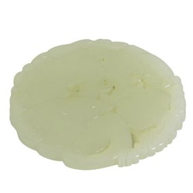 A Chinese white jade circular pendant
