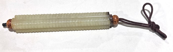 A Chinese celadon jade cong form bead
