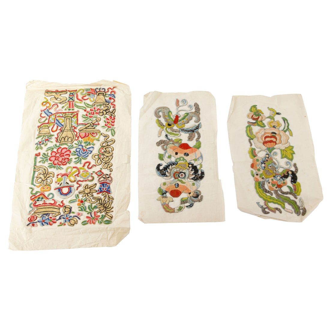 (lot of 3) Chinese embroidered articles: (lot of 3) Chinese embroidered articles. Comprising one forbidden stitched 'hundred antiques' panel, and a pair of embroidered flower and bat panels, late 19th century, from 9"h x 3.5"w to 11"h x 5.5"