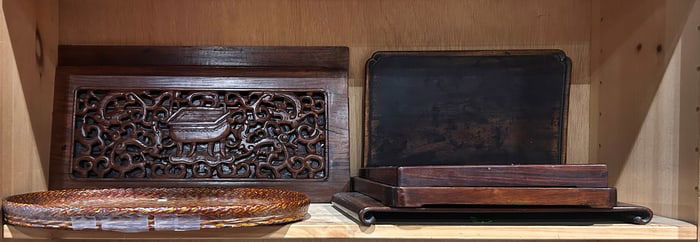A shelf of Chinese and Japanese wood carvings