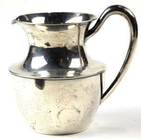 An Arts & Crafts Shreve sterling water pitcher, initialed 'D' in Gothic script, stamped '3 1/2 pints