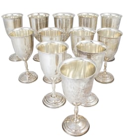 A suite of twelve Mexican Taxco sterling silver chalices