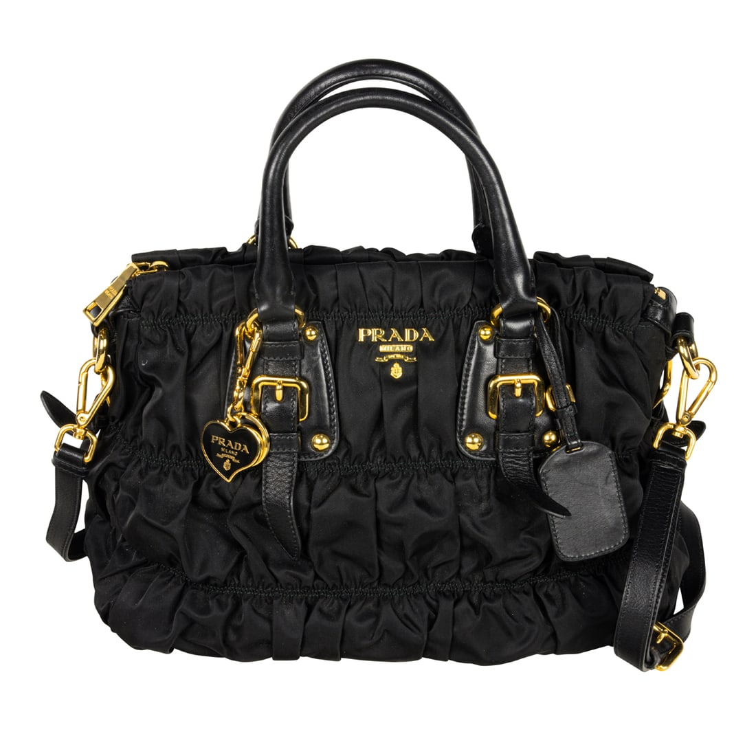 A Prada 'Tessuto Gaufre' black nylon handbag: A Prada 'Tessuto Gaufre' black nylon handbag, embellished with gold tone hardware, black leather trim, double top handle, shoulder strap, enamel heart key chain and luggage tag, dust bag, approximatel
