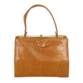 A Judith Leiber lizard skin handbag with gold tone hardware