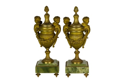 A pair of French Neoclassical style gilt bronze and green onyx mantel urns