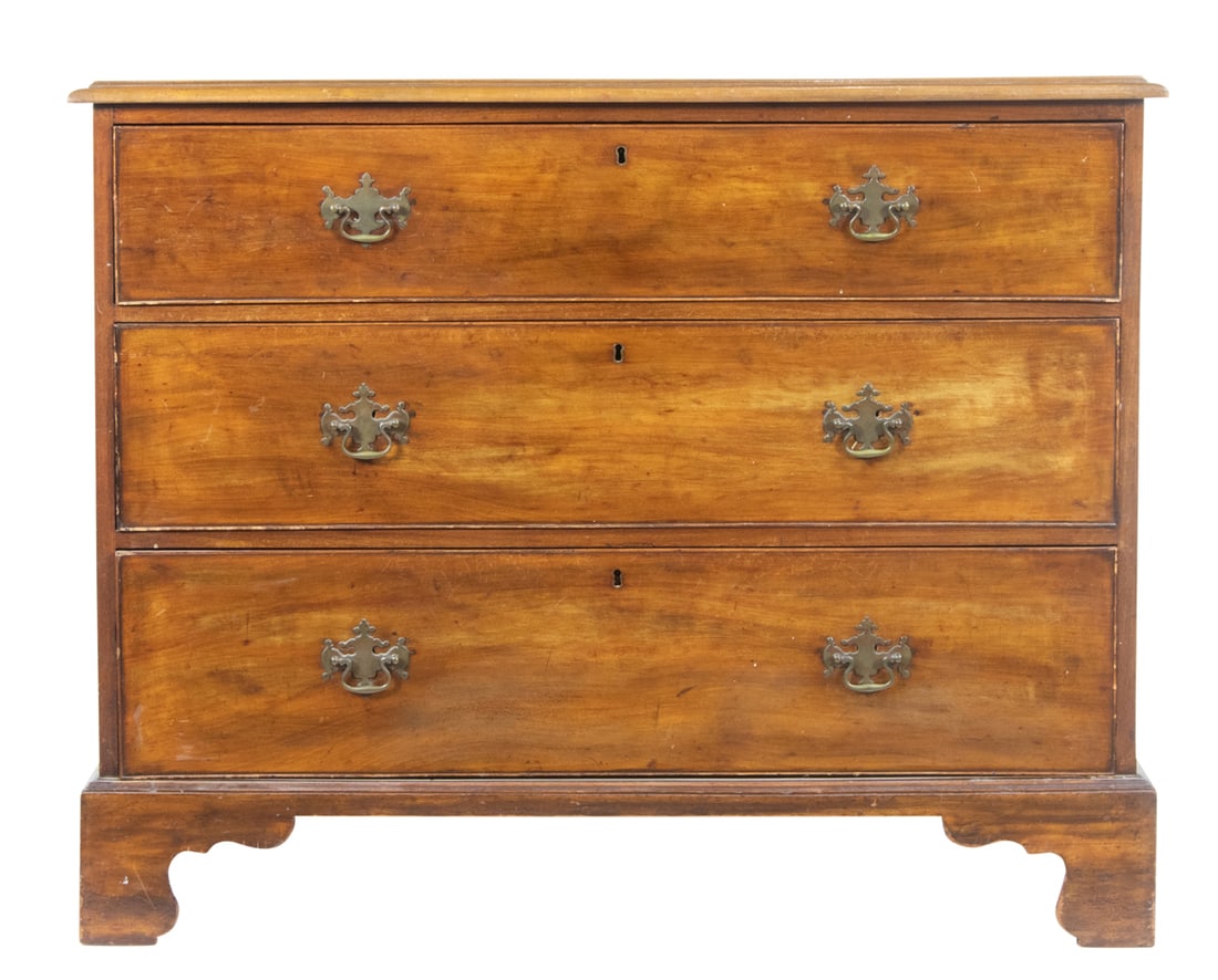 A George III walnut chest of drawers, circa 1800: A George III walnut chest of drawers, circa 1800, with three graduated drawers and rising on bracket feet, 35.5"h x 44.5"w x 23"d
