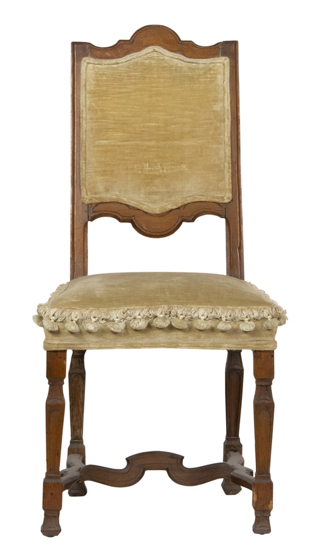 An Italian hall chair, circa 1790: An Italian hall chair, circa 1790, the tall back with incised detail with velvet upholstery, and rising on block and turned legs, 40"h