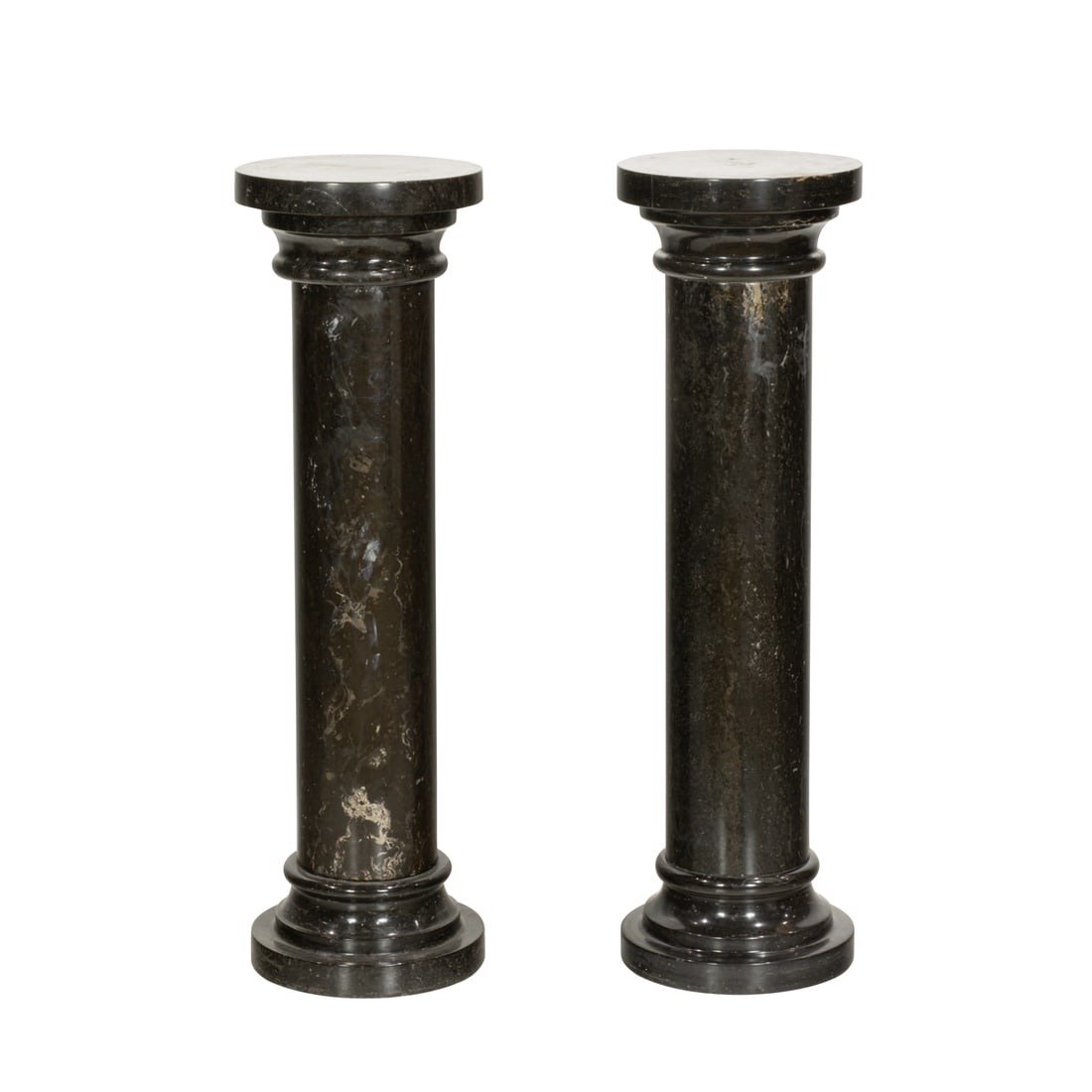A pair of Neoclassical style black marble columns: A pair of Neoclassical style black marble columns, each with round top on columnar standard on round stepped base, 39.5"h x 11.5"dia. Provenance: Estate of Lila Mae Schneider Azad, Modesto, California