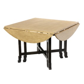 A Contemporary round dining table with folding sides