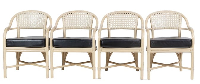 A set of four McGuire rattan dining arm chairs