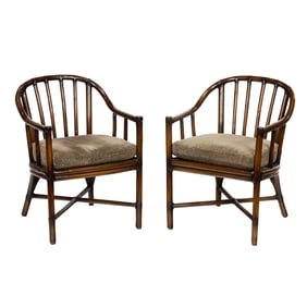 A pair of McGuire rattan barrel arm chairs