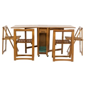 A Mid Century teak drop leaf table en suite with four folding chairs