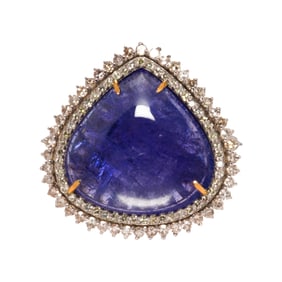 A tanzanite, diamond, silver and 14k gold ring