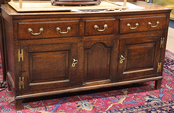 Georgian quartersawn oak sideboard: Georgian quartersawn oak sideboard, second half 18th century, having a rectangular top above the three drawer case surmounting the panelled doors and rising on square legs, retains an old surface, 34"
