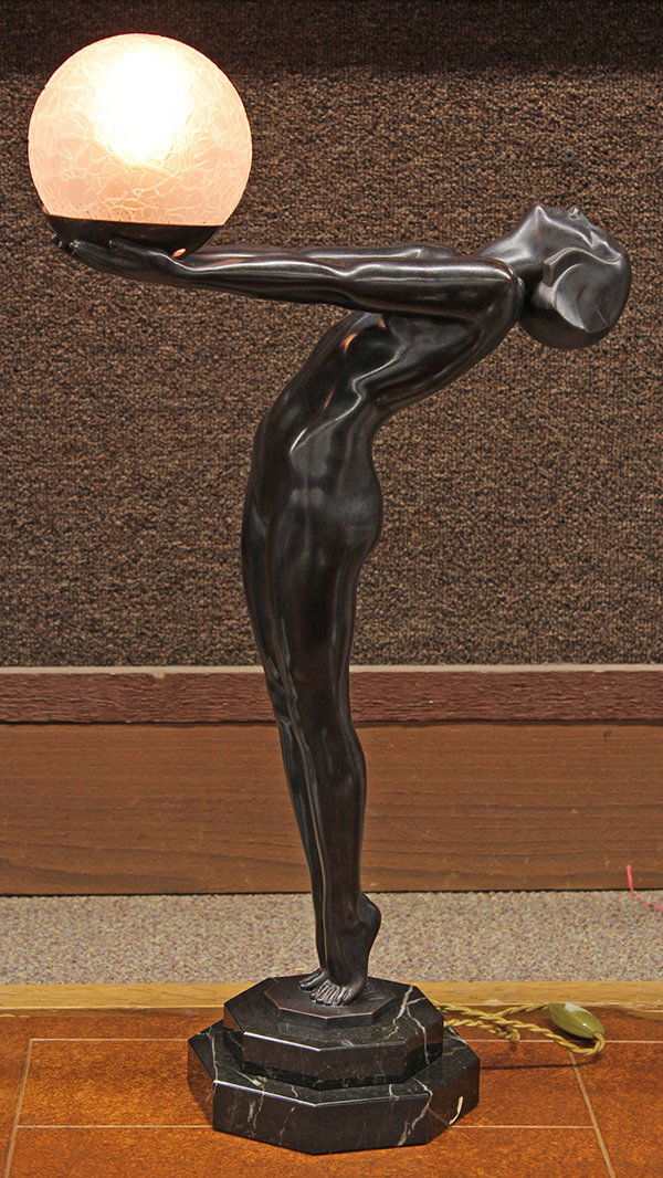 Max Le Verrier Art Deco patinated bronze lamp: Max Le Verrier (French 1891-1973) Art Deco patinated bronze lamp, circa 1930, sculpted as a sinuous maiden, her outstretched arms holding a large art glass spherical light, her head gazing skyward as