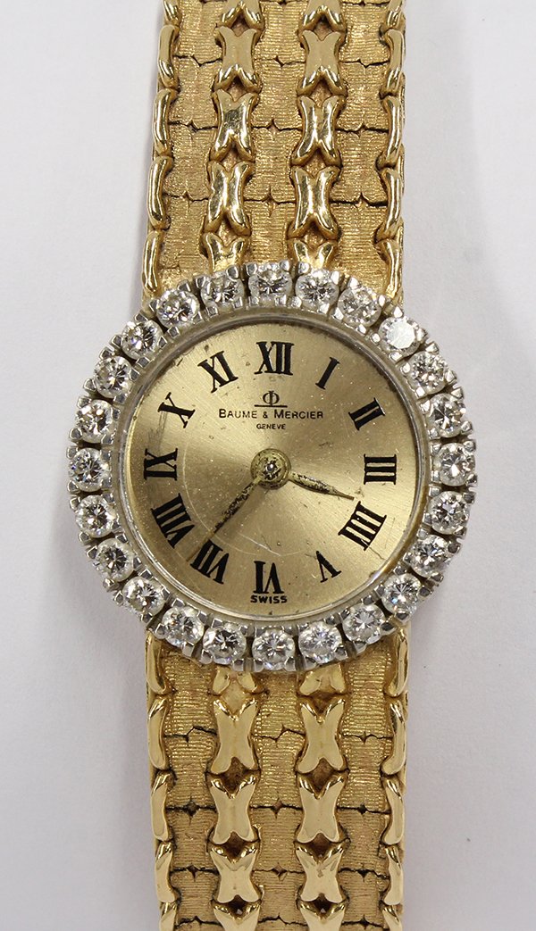 Lady's diamond 18K yellow gold Baume et Mercier watch w: Lady's diamond yellow gold wristwatch, Baume et Mercier Swiss. Estimated total diamond weight 0.96 carats; back wind movement; eighteen karat gold; dial signed Baume & Mercier; bracelet signed Piaget;