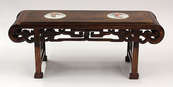 Chinese Wooden Stool/Stand with Porcelain Roundels: Chinese hardwood stand in the form of an altar table, the top set with two polychrome enameled porcelain roundels each decorated with children surmounted on a qilin, in contrast with the apron reticul