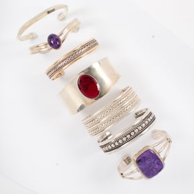 A group of seven silver cuffs