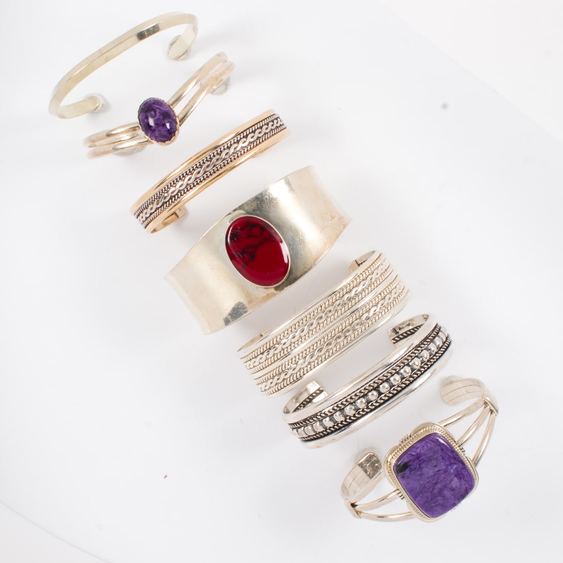 A group of seven silver cuffs