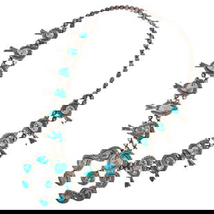 A Native American turquoise and silver squash blossom necklace: A Native American turquoise and silver squash blossom necklaceset with numerous turquoise cabochons of varied size and shape: 303.11 grams gross