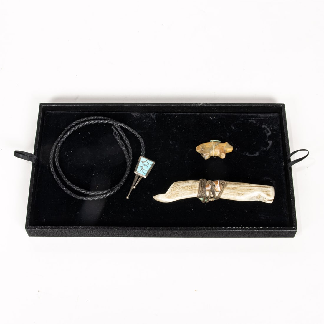 A Zuni fetish of buffalo carrying arrowhed, a antler bone tool tied to shell and turqouise, and a: A Zuni fetish of buffalo carrying arrowhed, a antler bone tool tied to shell and turqouise, and a turquoise inlaid silver bolo tie