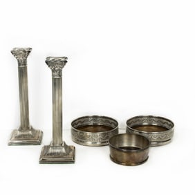 An assembled group, comprising pair of silver columnar candlesticks and (3) silver plated wine