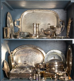 A large grouping of silverplate, including a vintage Sheffield tea tray, platters, covered casserole