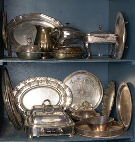 A large grouping of silverplate, including a vintage Sheffield double entree dish with warming tray,