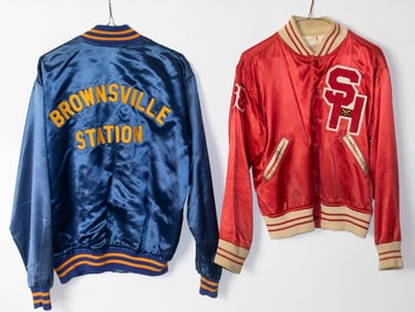 Two vintage high school or minor league silk baseball jackets: one with 'SH' logo and Brownsville